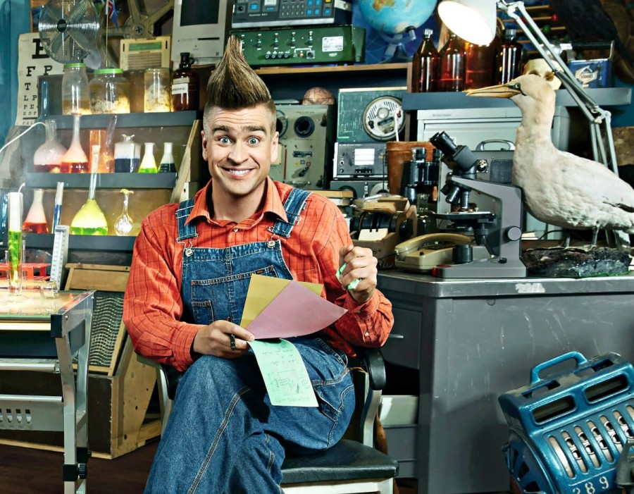 Vísinda Villi / Science Guy Villi Vísinda Villi situr á stól inni á rannsóknarstofu sem er full af tilraunaglösum og smásjám.